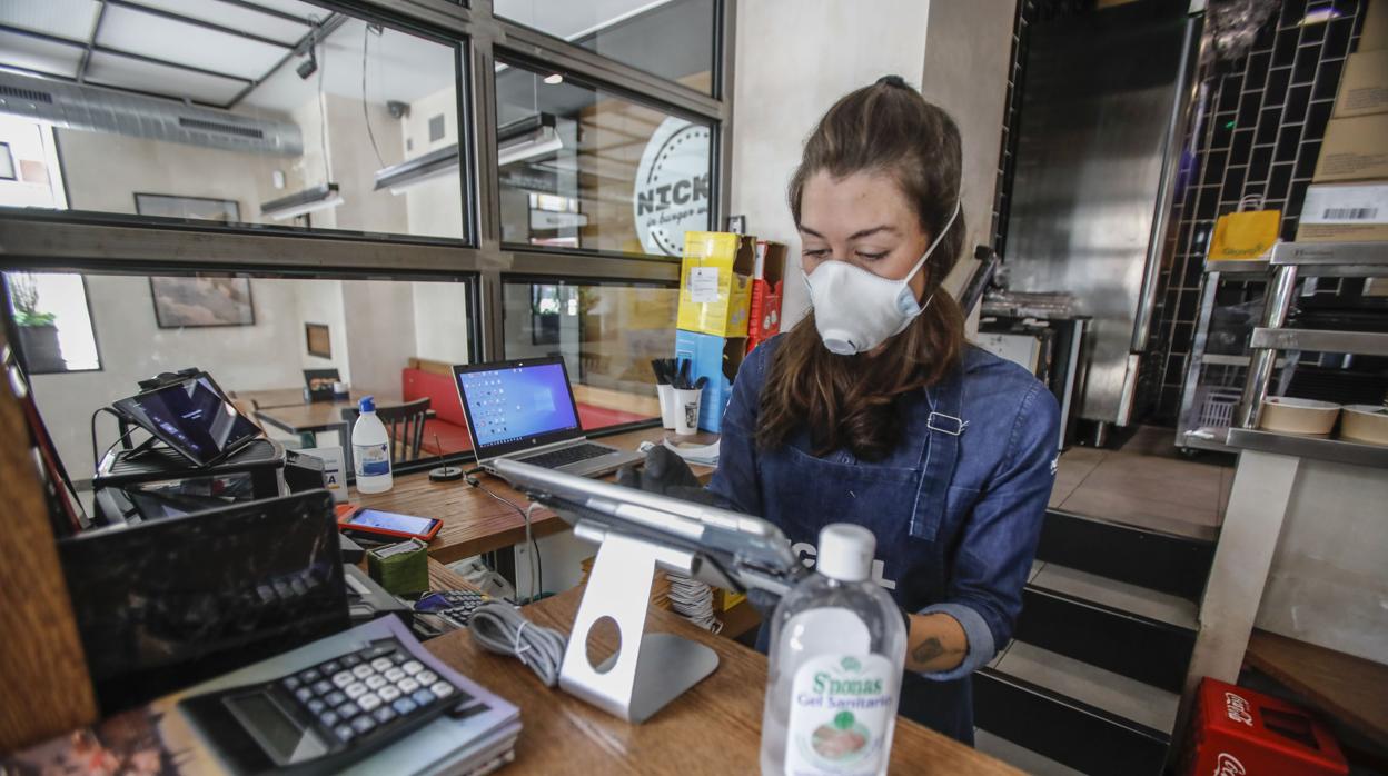 Una trabajadora con mascarilla en uno de los locales hosteleros