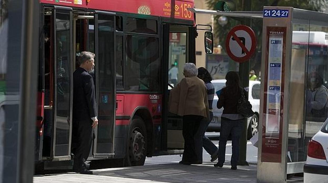 Usuarios de Tussam en una de las paradas de autobuses con marquesinas