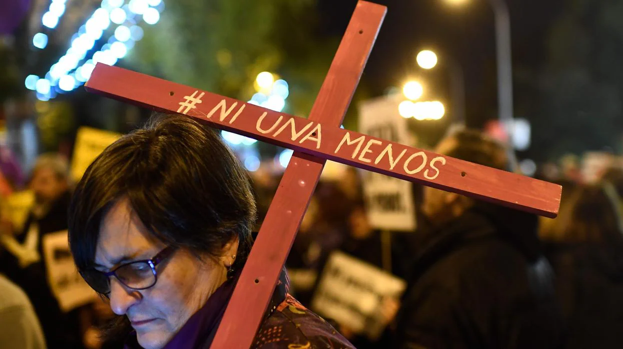 Una mujer sostiene una cruz con el lema «Ni una menos» en la marcha de ayer en Madrid