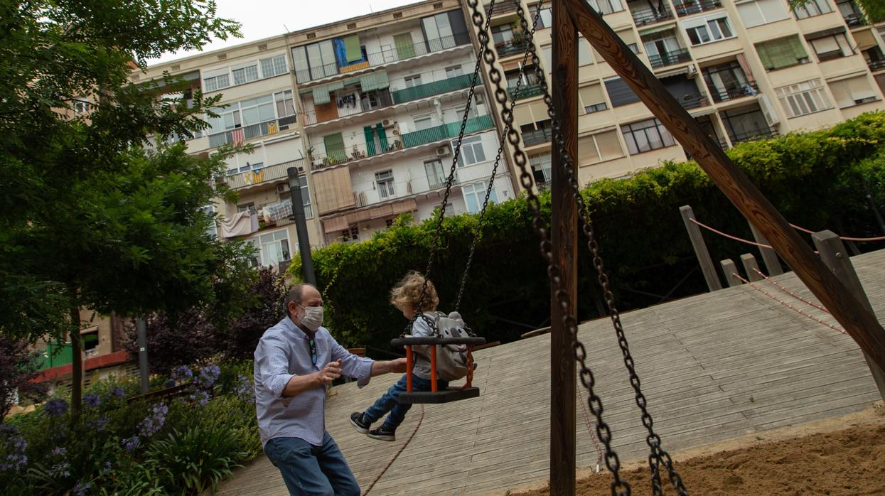 Un abuelo con su nieta en un parque urbano de Barcelona