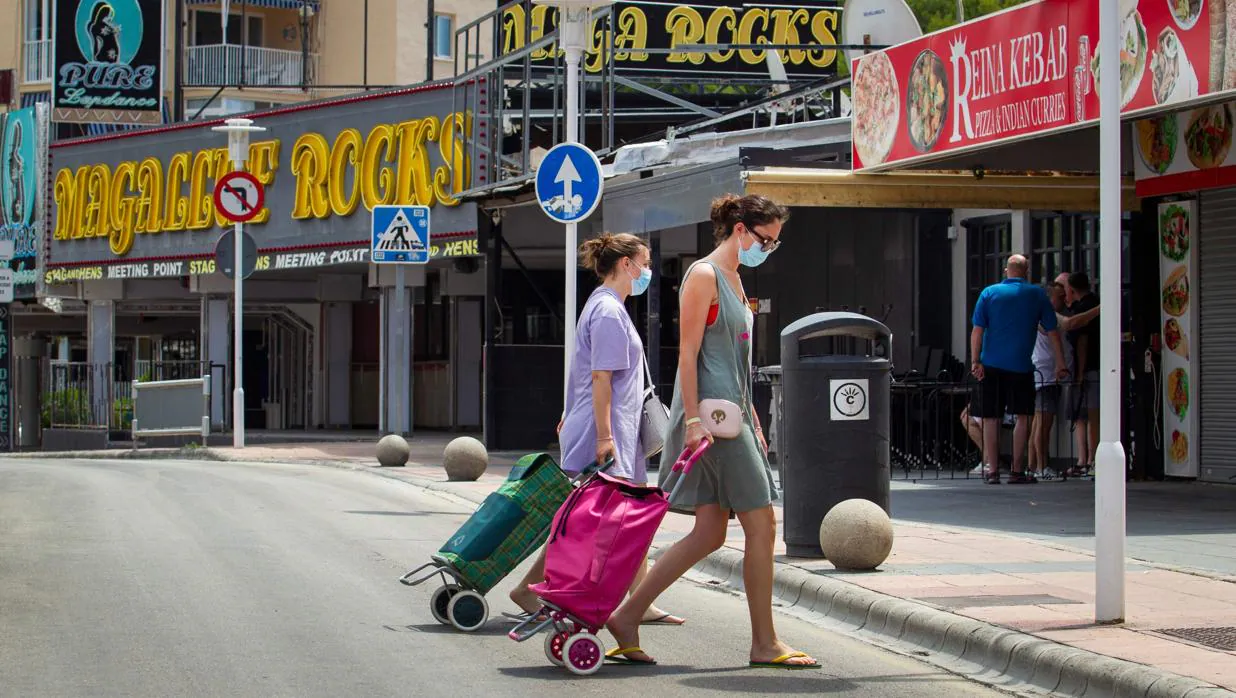 Varias mujeres caminan en la calle Punta Ballena de Magaluf, con los bares cerrados