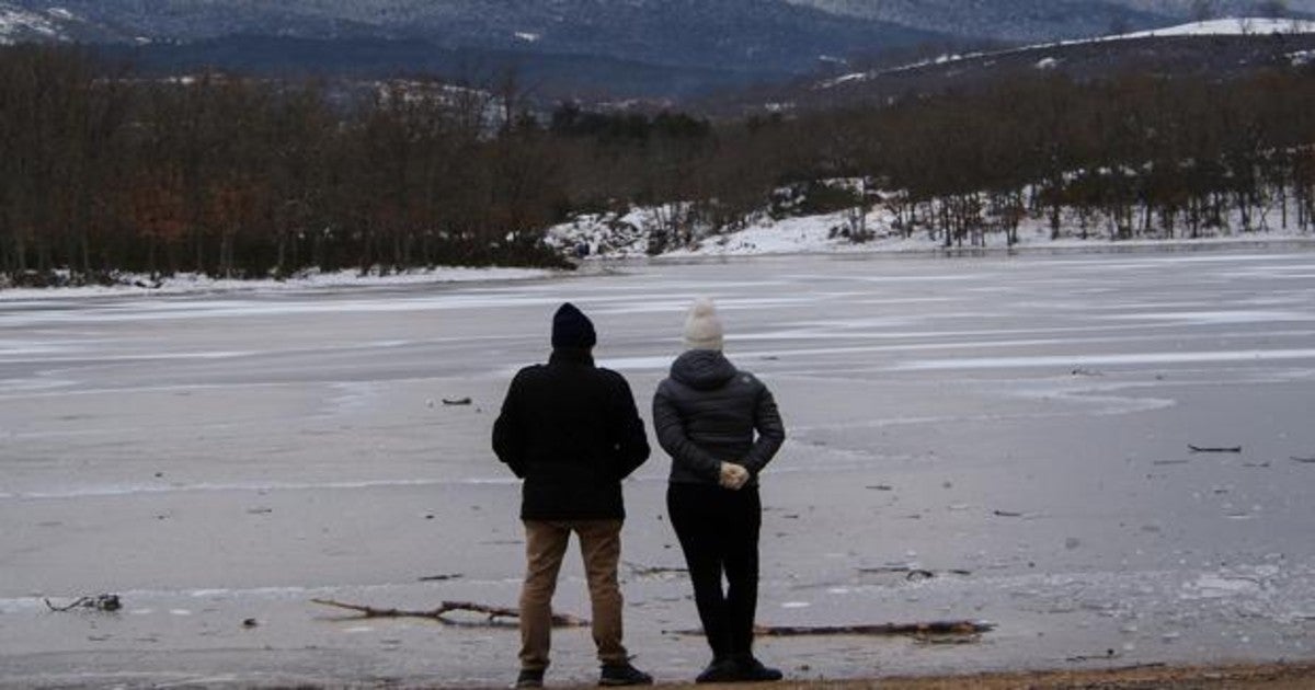 Dos personas contemplan el embalse de El Pontón Alto, en Segovia, cuya superficie se encuentra helada debido a las bajas temperaturas que se registran en la provincia