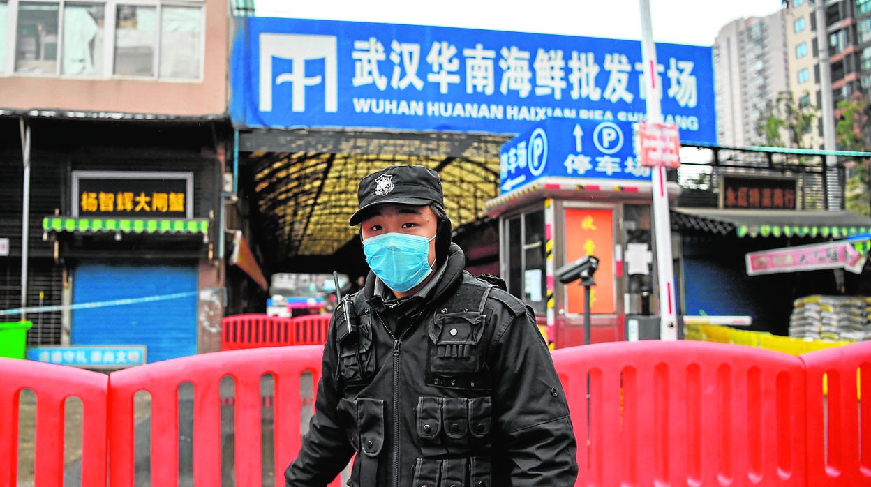 Un policía, en el mercado de Wuhan, donde empezó todo