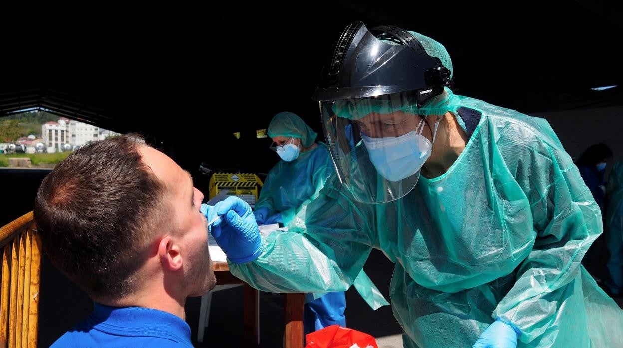 Un sanitario, realizando una prueba PCR