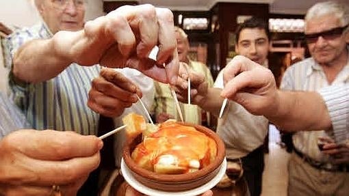 Bar "Jubera" de la calle Laurel de Logroño. Clientes del local se disponen a comer las patatas bravas (con mahonesa y un poco de picante)