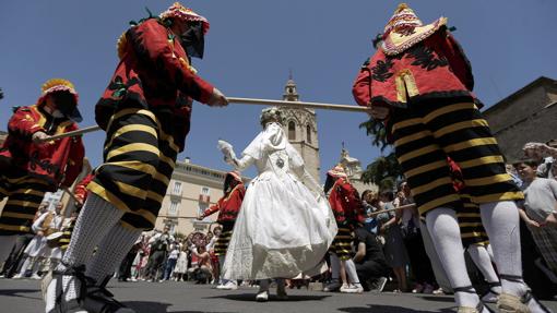 La Moma, en representación de la virtud, y los siete Momos, en representación de los siete pecados capitales, durante la procesión del Corpus Christi de Valencia